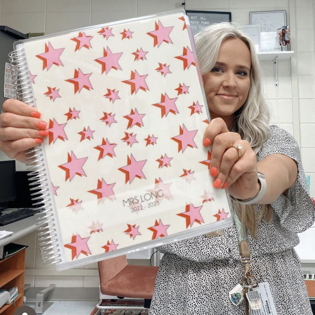 teacher holding a personalized planner