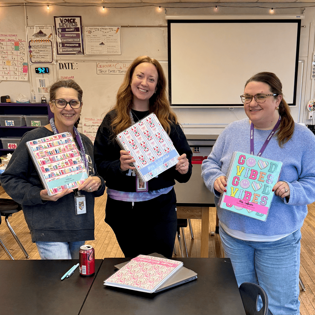 teachers holding multiple personalized planners